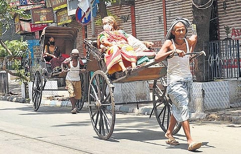 Passengers wear face masks on hand-pulled rickshaws in Kolkata | PTI