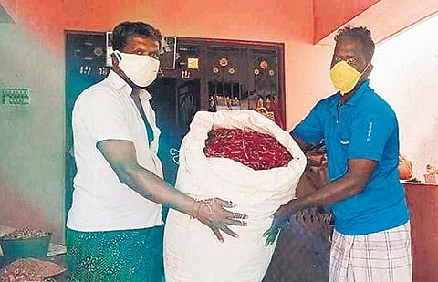 Farmer R Raja giving chillies in exchange for paddy at Chetti Thirukonam in Ariyalur | Express