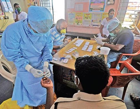 Medical staff testing a policeman for COVID-19 using rapid test kit. (Photo | Prasant Madugula, EPS)
