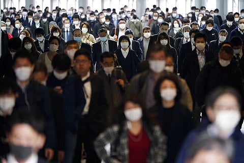 A station passageway is crowded with commuters wearing face mask during a rush hour in Tokyo. (Photo | AP)