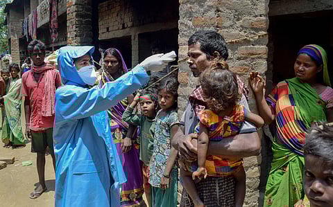 A health worker screens a labourer working at a brick kiln as his family members look on during the nationwide lockdown to curb the spread of coronavirus in Nadia district Tuesday April 28 2020. (Photo | PTI)