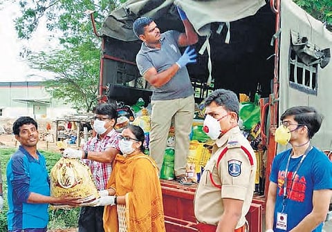 Cops lend a hand in distribution of groceries by NGOs across the city