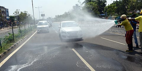Odisha Fire Service personnel sanitizing a strech from Rajmahal to Sishu Bhawan square during lockdown in Bhubaneswar. (File photo| EPS, Biswanath Swain)
