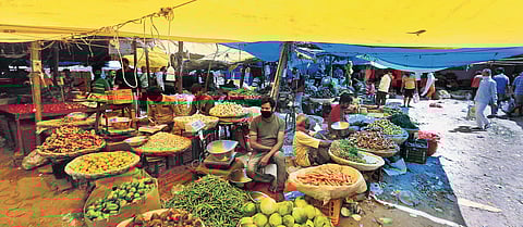 Vegetable vendors wait for customers at a market in Delhi on Thursday during the ongoing lockdown. (Photo | Shekhar Yadav, EPS)
