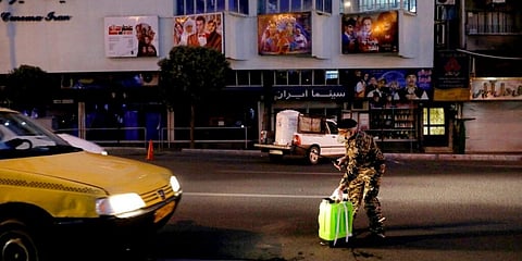 A Revolutionary Guard member takes part in disinfecting the city to help prevent the spread of coronavirus in downtown Tehran. (Photo | AP)
