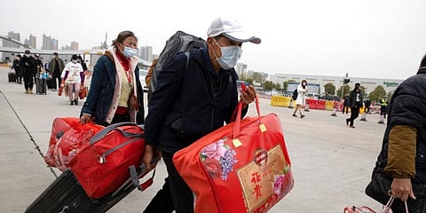 A man crosses the expressway gate at the border into Wuhan city in central China's Hubei province. (Photo | AP)