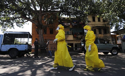 Sri Lankan health officials arrive to collect swab specimen from the suspected COVID-19 cases in a residential neighborhood during lockdown in Colombo, Sri Lanka, Thursday, April 16, 2020. (Photo | AP)