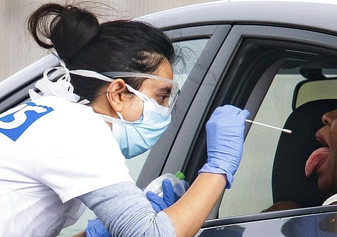 A medical worker takes a swab at a drive-in coronavirus testing facility at the Chessington World of Adventures Resort in Chessington, England, Wednesday April 29, 2020. (Photo | AP)