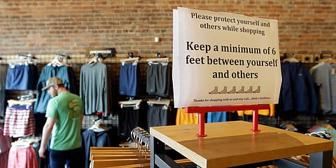 A sign reminding customers of social distancing is posted in the Bink's Outfitters store in Murfreesboro, Tennessee. (File photo| AP)