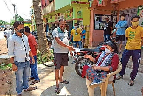 Raghunathpur sarpanch Pramod Jena paying fine for not wearing mask (Photo | EPS)