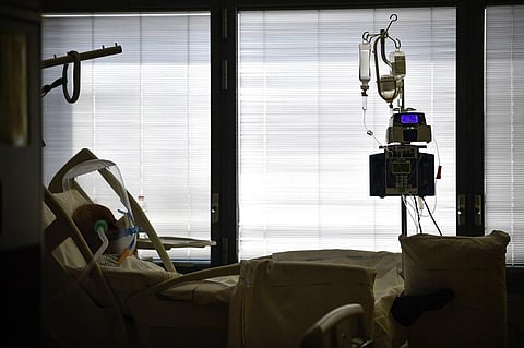 A Covid-19 patient wears a ventilated respiratory device over his head as he lies in a hospital bed at Bergamo's Papa Giovanni XXIII hospital, northern Italy, Friday, April 3, 2020. (Photo | AP)