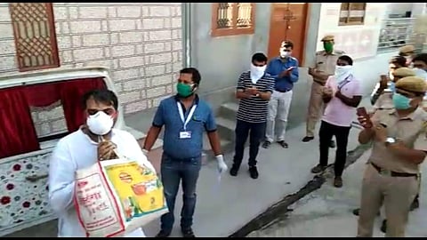 Photograph of the survivor being greeted at his home.