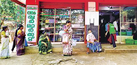 Shoppers wait patiently outside a Supplyco supermarket at Njekkadu, near Kallambalam, in Thiruvananthapuram district maintaining a safe distance among themselves on Thursday as part of ‘social distancing’ to counter the community spread of Covid-19 | B P