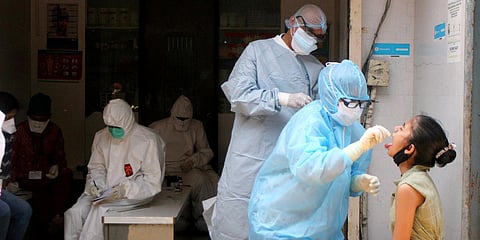 BMC medical workers taking samples of people who have cold and cough for testing of COVID-19, in Mumbai. (Photo| ANI)