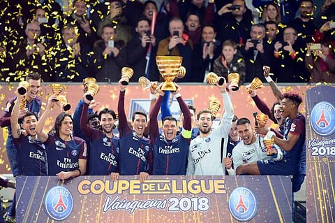Paris Saint Germain's Brazilian defender Thiago Silva (C) holds the French League Cup trophy as he celebrates with teammates. (File Photo | AFP)