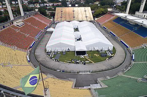 Workers set up a temporary field hospital to treat patients who have COVID-19 inside Pacaembu stadium in Sao Paulo, Brazil, Monday, March 30, 2020. (Photo | AP)