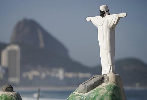 A sand sculpture of Rio de Janeiro's iconic Christ the Redeemer wearing a black mask during the new coronavirus pandemic stands on an empty Copacabana beach, Rio de Janeiro, Brazil, Monday, April 6, 2020. (Photo | AP)