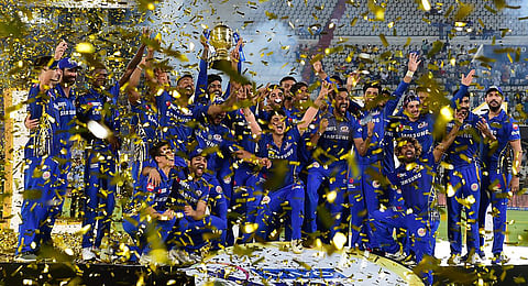 Mumbai Indians skipper Rohit Sharma with his teammates celebrating with Indian Premier League 2019 winning trophy. (File photo | PTI)