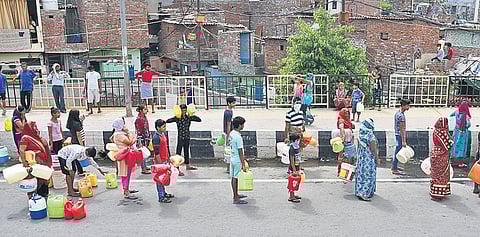 People queue up to collect water from a tanker during the nationwide lockdown on Sunday | Parveen Negi
