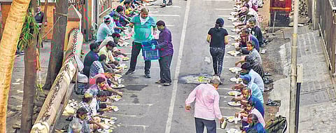 Volunteers distribute food to poor and migrant workers during the nationwide lockdown in Mumbai on Wednesday | PTI