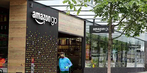 A person wearing a mask jogs past an Amazon Go store, Thursday, April 30, 2020, in downtown Seattle. (Photo | AP)