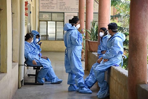 Medics wearing protective suits are seen at a hospital during the nationwide lockdown imposed in wake of the coronavirus pandemic in Bengaluru Friday May 1 2020. (Photo | PTI)