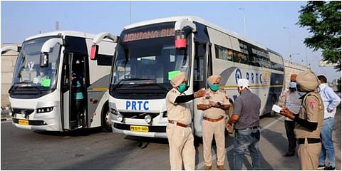 Punjab police checking details of passengers travelling in a bus, who will be subjected to a mandatory 21-day quarantine. (File Photo | PTI)