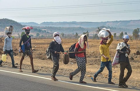 Migrants with their belongings walk towards their native places on the Mumbai-Nashik highway during the nationwide lockdown in wake of the coronavirus pandemic in Thane. (Photo | PTI)