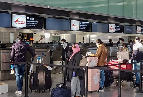 Indian nationals stranded in US wait to check-in at an airport before boarding a plane back to their home country as part of 'Vande Bharat Mission'. (Photo | PTI)