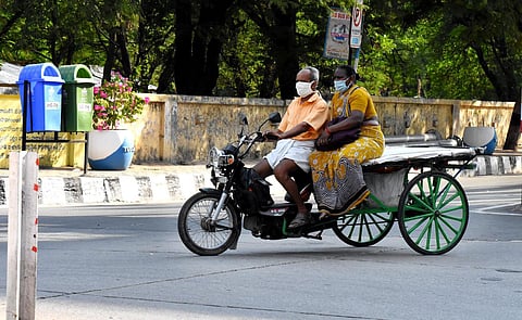 A old man and a lay travelling in a two wheeler aka rickshaw. (Photo| EPS/ Madhav K)
