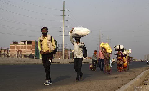 Migrant workers on their way to back home at national highway in Ghaziabad during the nationwide lockdown to control the spread of Coronavirus on Saturday. (Photo | Anil Shakya/EPS)