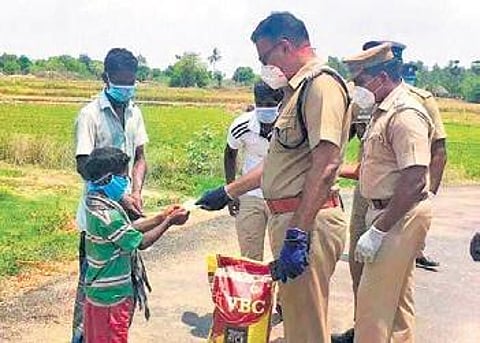 S Jeyakumar, Villupuram SP, with 10-year-old Jeeva | Express