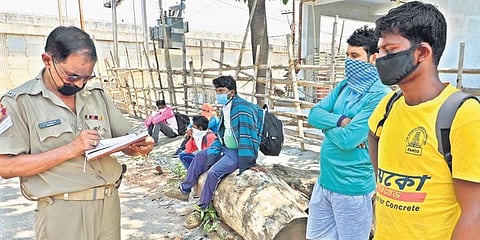 Migrant workers from Madhya Pradesh being quizzed by police in Bhubaneswar on Saturday. (Photo | irfana, EPS)
