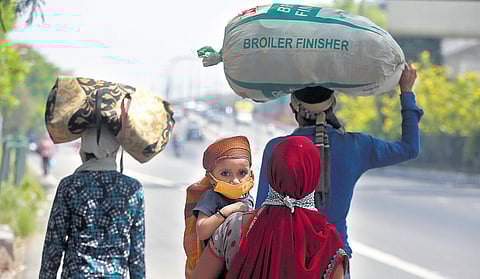 Migrant workers look to walk their way back home in New Delhi on Saturday. (Photo| Shekhar Yadav, EPS)