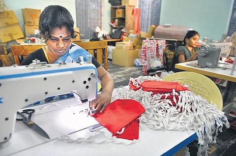 Shanthi (in blue saree) and a few other differently abled women who stay with her at the Corporation shelter, in a joint effort, are stitching masks at Nungamabakkam in Chennai. (PHOTO | DEBADATTA MALLICK, EPS)