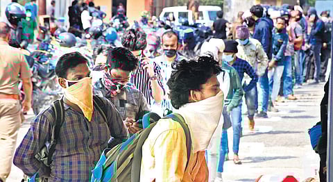 People waiting at the commercial tax checkpost at Walayar for verification of their documents. (Photo | EPS)