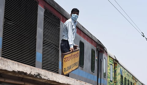 A worker seen engaged in cleaning the railway coaches at the yard in New Delhi Railway station on Monday. (Photo | Parveen Negi/EPS)