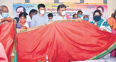 MAUD Minister KT Rama Rao, along with officials, inspects a saree manufactured at the Textile Park in Sircilla on Monday