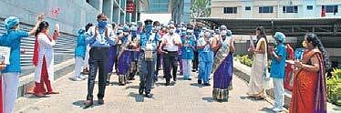 Nurses honoured at KIMS Hospital, Secunderabad; (left) Residents of Partani Towers, Musheerabad, felicitate nurse Pallavi for her services on Nurses Day