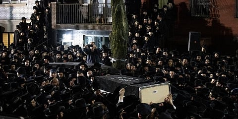 Jewish men carry the casket of a hate crime victim outside a Brooklyn synagogue following his funeral in New York. (File Photo | AP)