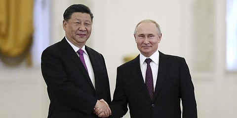 Russian President Vladimir Putin (R) and Chinese President Xi Jinping shake hands during their meeting in the Kremlin in Moscow. (File Photo | AP)