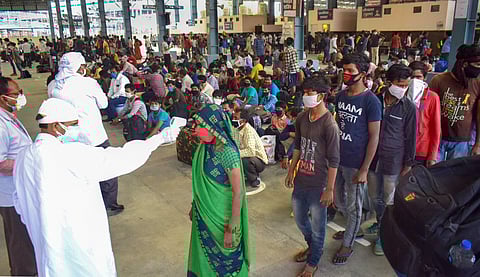 Migrants who have arrived from Ahmedabad in Gujarat undergo thermal screening after arriving by a special train at Prayagraj railway station during the ongoing COVID-19 lockdown in Prayagraj Wednesday May 13 2020. (Photo | PTI)