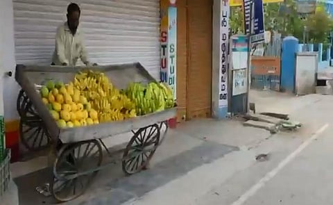 Vaniyambadi Municipal Commissioner Cecil Thomas pushing over a vegetable seller's cart. (Photo | Twitter Screengrab)