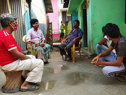 Kumar (in blue shirt) with some of the migrant workers (Photo | EPS)