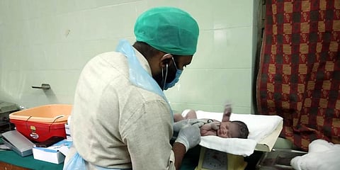 Dr Mukhram examines the baby girl at Gangaram Hospital in Mahabubabad district. (Photo | EPS)
