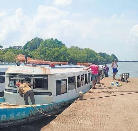 Employees of SWTD Ernakulam engaged in painting a boat