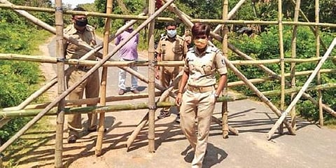 Police barricading the village after it was declared as a containment zone.