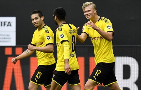 Dortmund's Norwegian forward Erling Braut Haaland (R) after scoring his side's second goal during the German first division Bundesliga football match BVB Borussia Dortmund v Schalke 04 on May 16, 2020. (Photo | AFP)
