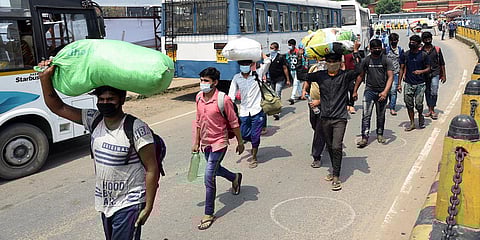 Migrants coming out of railway Station to board buses as they arrive from Rohtak by a Shramik Special Train during the ongoing COVID-19 lockdown in Patna. (Photo| PTI)