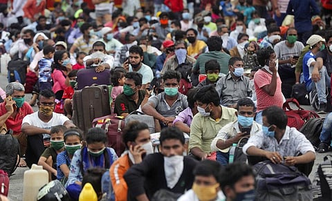 Migrant workers from other states wait outside a railway station to catch a train to return to their homes, in Mumbai, India, Friday, May 15, 2020. (Photo | AP)